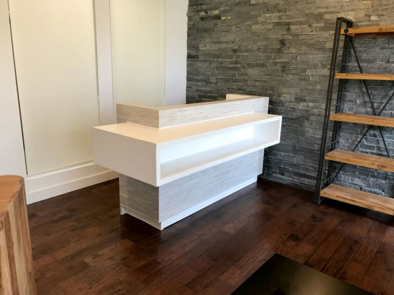 A feature stone wall and reception counter in a retail space.